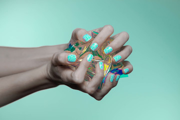 beautiful woman hands with holographic nail polish