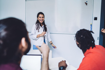 Laughing woman doing presentation for group mates