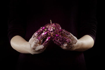 beautiful woman hands with glitter holding apple close up