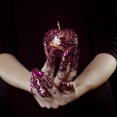beautiful woman hands with glitter holding apple close up - 304488949