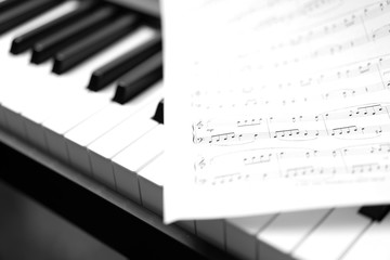 Classic piano and musical sheet . Black and white photo, Musical Background