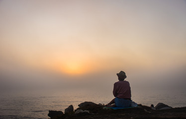 woman enjoying a foggy sunset