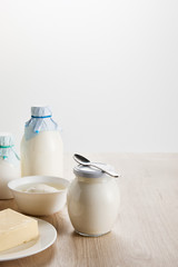 fresh organic dairy products on wooden table isolated on white