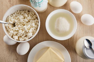 top view of fresh organic dairy products and eggs on wooden table