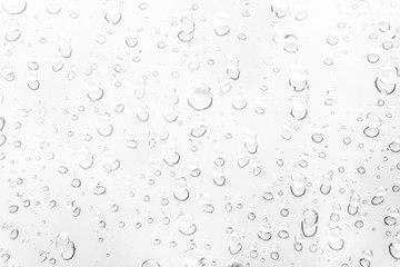 Fototapeta na wymiar Raindrop water dew drop on glass wet white gray blue background.