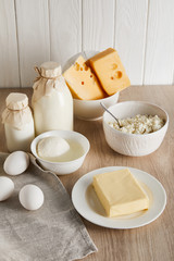 Fototapeta na wymiar delicious fresh dairy products and eggs on white wooden background