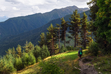Sunny autumn day in Svanety mountains with tourist hiking