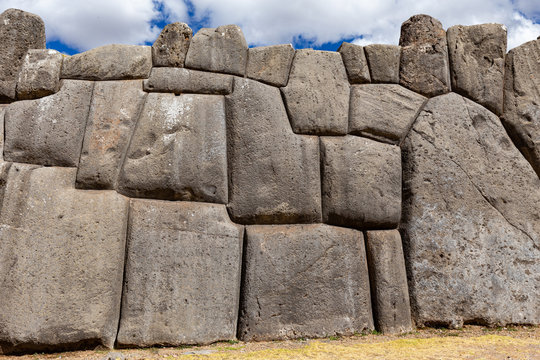 Image of llamas on a stone wall of Sacsayhuaman. Cusco, Peru.