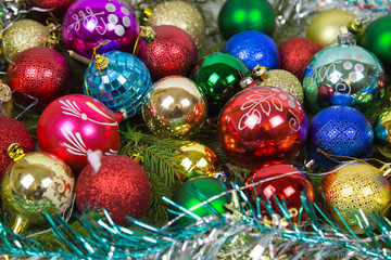 Balls colorful bright Christmas with green branches of spruce and shiny tinsel. Toys, New year, decorations.