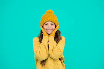 Cute girl enjoy winter style. Little kid wear knitted hat. Stay warm. Small child wear hat and sweater. Cold weather. Skin care. Thermal protection concept. Thermal insulation. Thermal garment shop