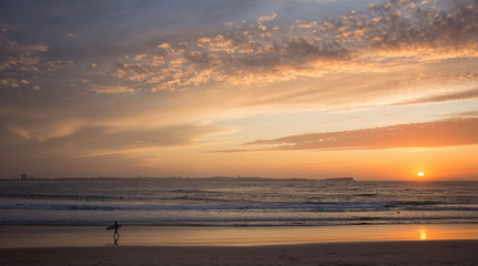 Fototapeta na wymiar silhouette of a surfer at sunset
