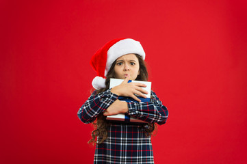 Little girl child in santa red hat. Christmas shopping. Happy winter holidays. Small naughty girl. Present for Xmas. Childhood. New year party. Santa claus kid. its only mine