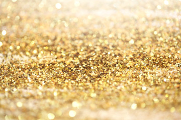 Gold (bronze) glitter shine dots confetti. Abstract light blink sparkle defocus backgound.