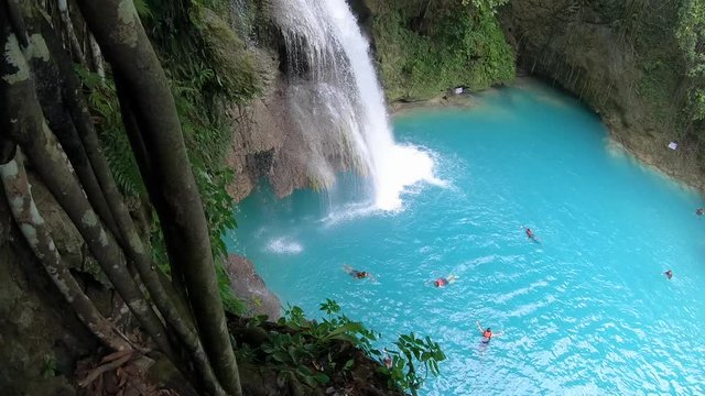 Tropical waterfall in rainforest. Kawasan Falls on Cebu island in Philippines.