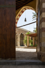 Entrance door of public historic Mamluk era Amir Aqsunqur Mosque, Blue Mosque, with bricks stone wall reveling courtyard of the mosque, Cairo, Egypt