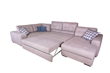Corner sofa is spread into a large sleeping place with multicolored cushions