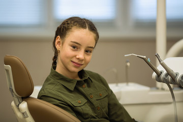 Portrait of a cute girl in the dental office. Health care and stomatology concept.