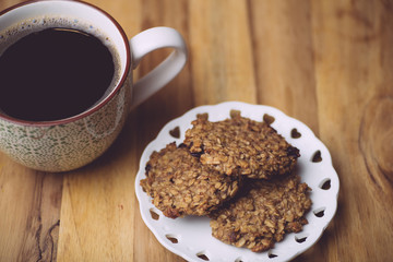 Morning coffe with oatmeal cookies on a wooden table. Morning coffe concept