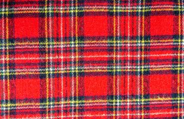 Tartan - a material with a classic Scottish pattern. Pattern consisting of criss-crossed horizontal and vertical bands in multiple colours.