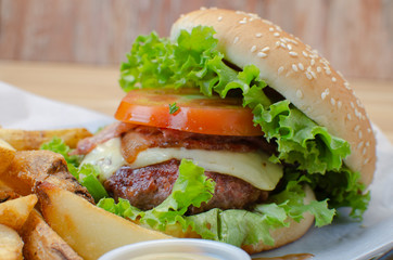 double cheese and meat burger, accompanied by French fries