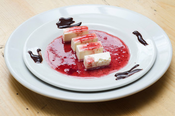  cheese dessert and red fruit sauce