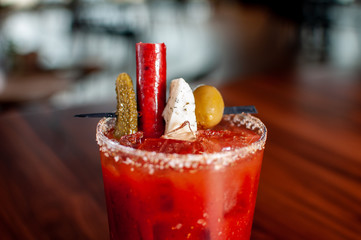 Bloody Mary Closeup with Pickle, Beefstick, Cheese, and Olive Garnish © Zachary