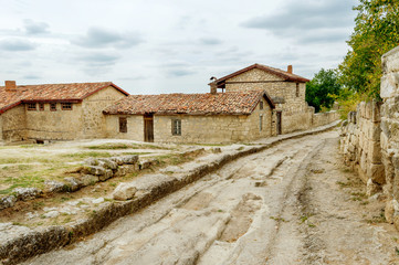 Fototapeta na wymiar Ancient stony road through Chufut-Kale, medieval cave settlement of Crimean Karaites, Crimea