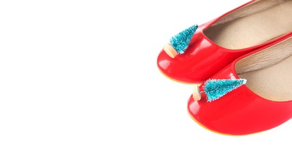 Red shoes with toy christmas tree on white background. Christmas sale