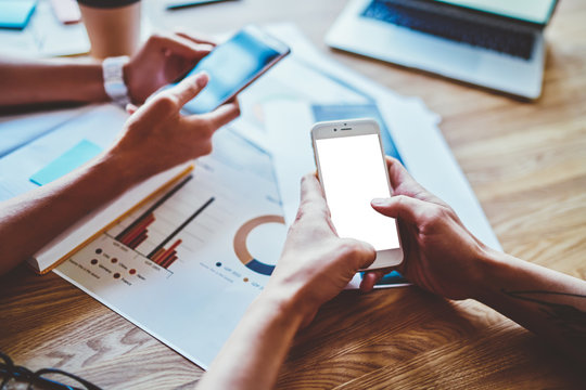 Cropped view of hands holding modern mobile phones and typing text on display during chatting online with followers in social networks using 4g wireless, concept of sharing media between devices