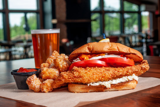 Walleye Sandwich Closeup With Tater Tots , Ketchup, And A Beer