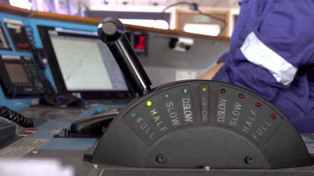 navigator set black engine control stick of a ship into half ahead mode
