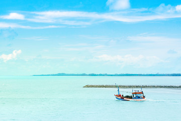 Fototapeta na wymiar Beautiful seascape view nature with fishing boat and clear water sea blue sky clouds background in tropical ocean sea summer season Thailand.