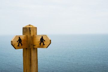 Close up of wooden signpost on hiking trail