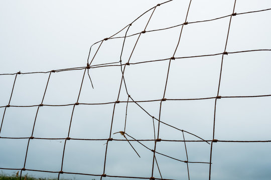 Close up of broken mesh fence