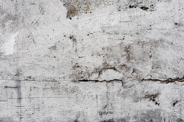 Texture of a concrete wall with cracks and scratches which can be used as a background