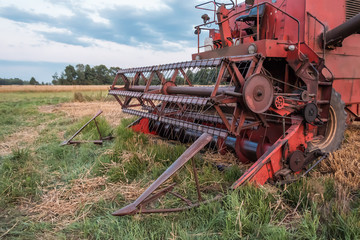 old combine works in the field