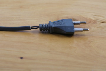 Electric plug with a damaged cord. Danger to use.