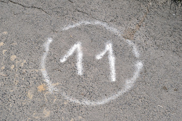 Circled Number Eleven Spray Painted on Tarmac Path 6531-042