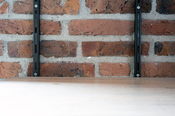 Empty wood shelf on old brick wall background, grunge industrial interior background texture
