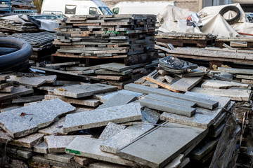 piles broken granite slices trash dump pollution