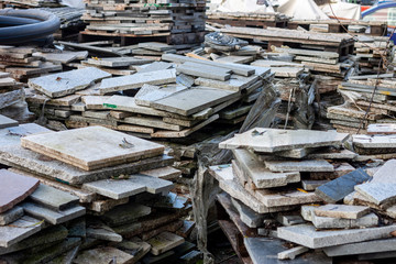 piles broken granite slices trash dump pollution