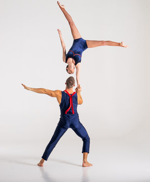 Duo Of Acrobats Showing hand to hand Trick, Isolated On White