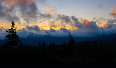 sunset mountain sky blue colorful autumn sun light yellow orange clouds tree smoke fog haze