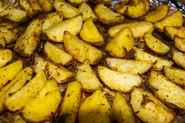 Fried potatoes in the oven.Cooking baked potato. Potatoes peasant. Potatoes with spices. Potatoes on the foil.