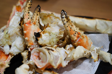 Close up and selective focus of big giant King crab legs grilled selling in market , food and travel concept.