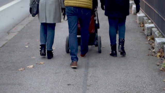 Slow motion of unknown familiy walking in winter season. Street scene in german city munich