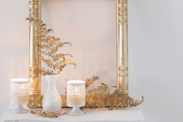  interior decor with burning candles on white wooden shelf