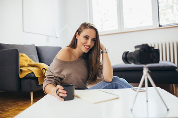 woman vlogger recording a vlog from her home