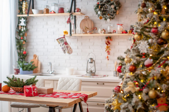 kitchen decorated with pine garlands and Christmas toys.
