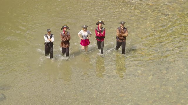 Overhead Shot Of A Gang Of Pirates Walking On A River
